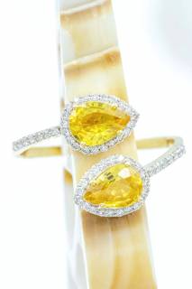 Ring with yellow sapphires and diamonds in an embracing composition