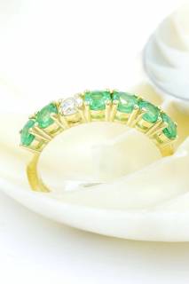 Ring with emeralds and diamond in a row
